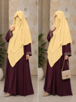 Yellow three layer chiffon hijab with matching niqab displayed on a mannequin, modest Islamic fashion.